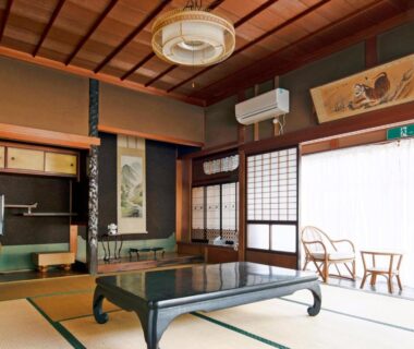 Traditional tatami room with low lacquered table, shoji screens, tokonoma alcove and seating at Ryouriryokan Asahikan in Nara
