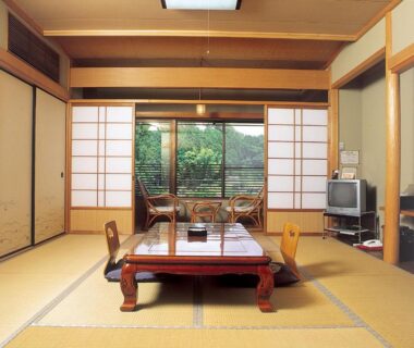 Traditional tatami room with low table and shoji screens at Ryujin Onsen Marui Ryokan in Wakayama, Kansai