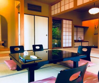Low tatami table with zabuton cushions and shoji screens at Ryutakuzenji in Gunma