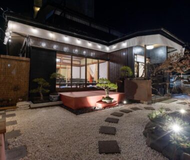 Lit entrance and stone path of SAKURA inn 白米 in Yamanashi with gravel garden