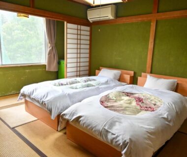Tatami room with twin beds and shoji screens at SDGs BASE AQUA PLUS in Ishikawa