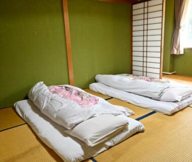 Two futon beds on tatami floor in a simple room at SDGs BASE AQUA PLUS in Ishikawa, Chūbu