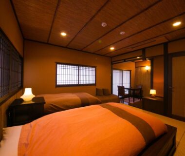 Twin beds on tatami with shoji screens at SEKIYA RESORT Bettei Haruki in Ōita, Kyūshū