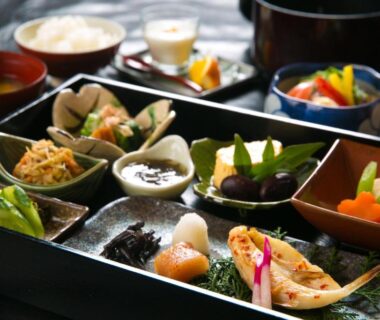 Lacquered tray with assorted small Japanese dishes at SEKIYA RESORT Bettei Haruki, Ōita
