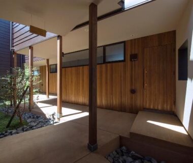 Covered wooden entrance corridor with stone edging at SEKIYA RESORT Terrace Midoubaru in Ōita, Kyūshū