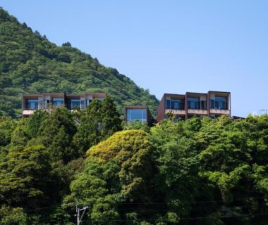 Resort buildings perched above verdant hillside at SEKIYA RESORT Terrace Midoubaru in Ōita, Kyūshū