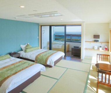 Bright tatami room with twin beds and balcony overlooking coast at SEVEN SEAS HOTEL ITO, Shizuoka