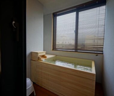 Wooden soaking tub with window in SEVEN SEAS HOTEL ITO room, Shizuoka