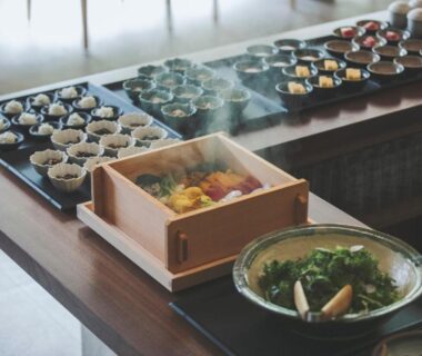 Wooden steamer box and assorted small dishes on buffet table at SOKI ATAMI in Shizuoka