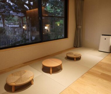 Tatami seating with low round tables and garden view at SPA TERRACE Shisui in Hyōgo
