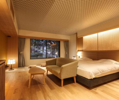 Spacious wooden-floored room with bed and seating area at SPA TERRACE Shisui, Hyōgo, Kansai