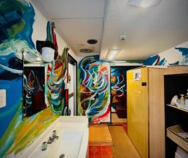 Colorful painted washroom with sink, mirror and wooden shelving at Sachinoyu Hotel Shiga Kogen, Nagano, Chūbu Japan