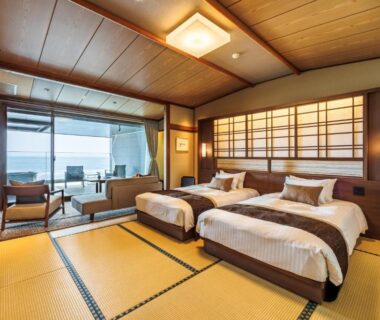 Tatami room with twin beds, shoji screens and coastal view at Sado Resort Hotel Azuma Niigata