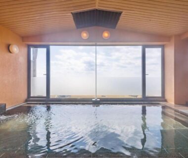 Large indoor onsen bath with floor to ceiling windows at Sado Resort Hotel Azuma, Niigata, Chūbu, Japan