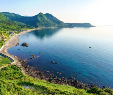 Rocky coastline and calm sea near Sado Ryosou Minato in Niigata Chubu