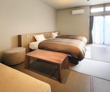 Tatami seating area with twin beds and low table at Saga Fuga, Saga, Kyushu