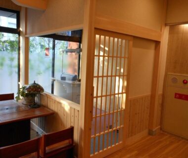 Interior with shoji screen, wooden floor, dining table and window at Saga Grace Hotel Kyoto