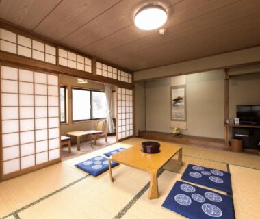 Tatami room with low table, zabuton cushions and shoji screens at Sagirisou in Nagano, Chūbu, Japan