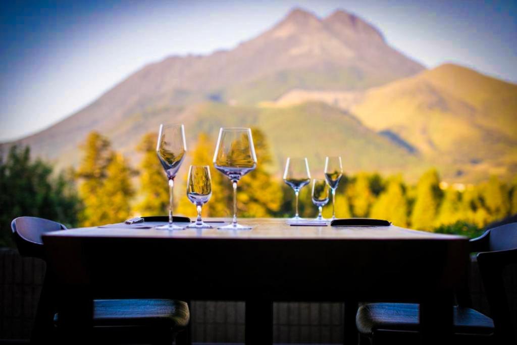 Outdoor Dining Table Mountain View Saigakukan Ōita Outdoor table set with wine glasses at Saigakukan, Ōita, Kyushu mountain in background
