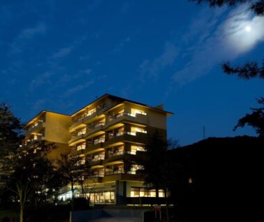 Multi-story building with illuminated balconies at dusk, Saiou no Miya in Mie prefecture