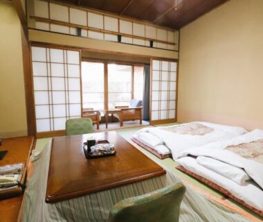 Traditional tatami room with futons, shoji screens and low table at Sakaenoyu Ryokan in Nagano, Chūbu, Japan
