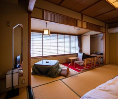 Tatami room with futon, low table, shoji screens and seating at Sakahijiri Nikko in Tochigi