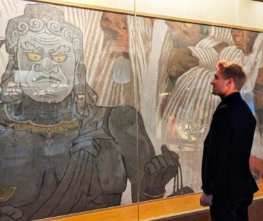 Person admiring large deity mural in Sakan lobby, Miyagi Tōhoku