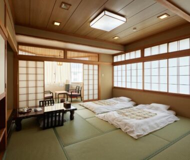 Tatami room with futon bedding and shoji screens at Sakura no Yakata Hotel in Yamanashi, Chūbu Japan