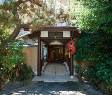 Wooden ryokan entrance with red lantern at Sakura no Yakata Hotel in Yamanashi, Chubu, Japan