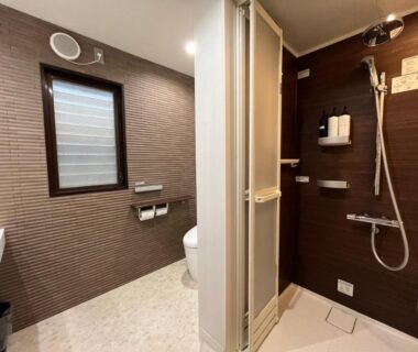 Compact bathroom with shower stall, toilet and sink at Sakuraya in Hiroshima, Chūgoku region