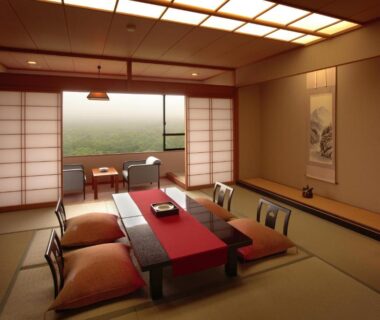Traditional tatami room with low table, floor cushions, shoji screens and tokonoma at Sansatei in Miyagi