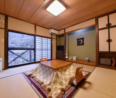 Tatami room with kotatsu, shoji screens and tokonoma at Sanso Matsuya in Ōita, Kyūshū
