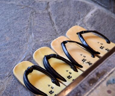 Three pairs of traditional geta sandals on a stone step at Sanso Matsuya in Oita