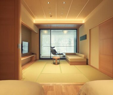 Spacious tatami room with low table, shoji screens, seating area and twin beds