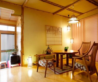 Tatami room seating with low table, wooden chairs, shoji screens and warm lantern lighting at Sansuisou, Kanagawa, Kantō