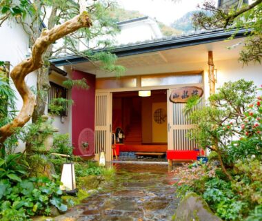 Stone path to Sansuisou entrance with wooden sliding doors and lush garden in Kanagawa, Kantō, Japan