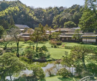 Manicured Japanese garden with pond and ryokan buildings at Sanyo-so in Shizuoka, Chūbu