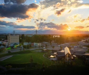 Aerial sunset over park and clustered buildings near Sasai Hotel area, Hokkaidō Japan