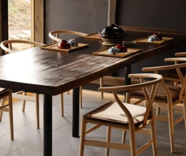Wooden dining table set with lacquerware at Satoyama Jujo The House, Niigata, Chūbu
