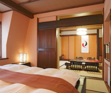 Japanese room with tatami, low table, shoji screens and twin beds at Sawaemon in Nagano, Chubu