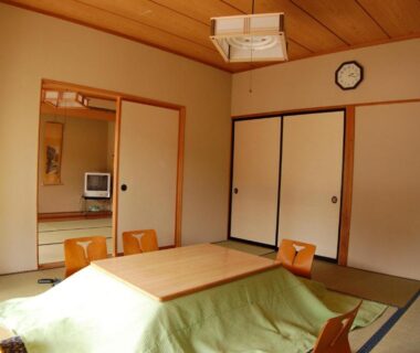 Traditional tatami room with low table and floor chairs at Sawatari Onsen Miyataya Ryokan, Gunma