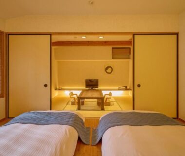 Twin beds in a tatami room with sliding doors at Seikansou, Kanagawa, Kantō, Japan