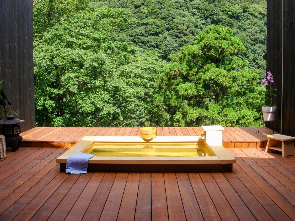 Outdoor Wooden Bath Seikansou Kanagawa Japan Wooden soaking tub on a deck overlooking lush forest at Seikansou in Kanagawa