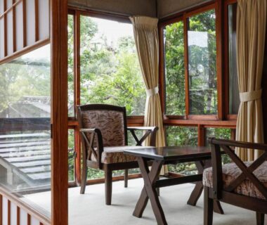 Interior seating area with tatami flooring, low wooden chairs and garden views at Seikiro Ryokan Kyoto
