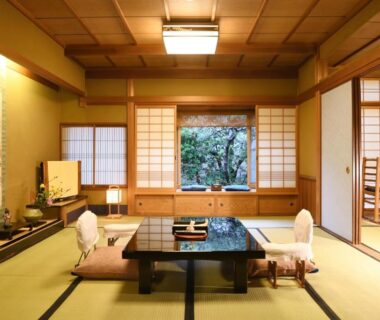 Traditional tatami room with low table, zabuton chairs and garden view at Seikoro Ryokan in Kyoto