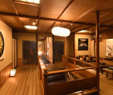 Traditional tatami lounge with wooden beams, low seating and shoji screens at Seikoro Ryokan in Kyoto
