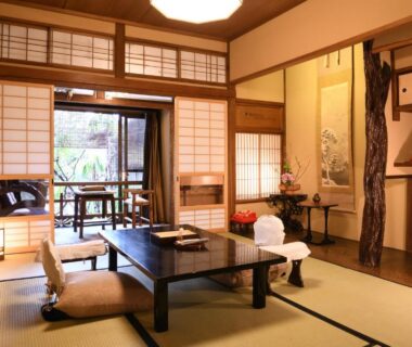 Traditional tatami room with low table, shoji screens and garden view at Seikoro Ryokan in Kyoto