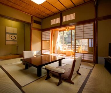 Tatami room with low table, shoji screens and garden view at Seiryu-so, Shizuoka