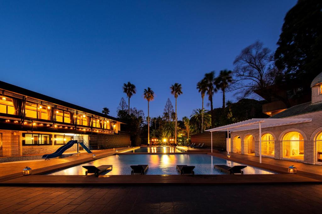 Twilight Outdoor Pool at Seiryu-so Shizuoka Illuminated outdoor pool with palms and lit ryokan buildings at Seiryu-so in Shizuoka, Chūbu