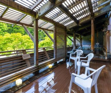 Wet wooden veranda with white chairs and lattice screens at Seiryukaku, Iwate, Tōhoku, Japan